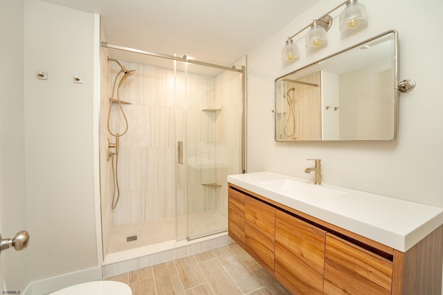 bathroom with vanity and a shower with shower door