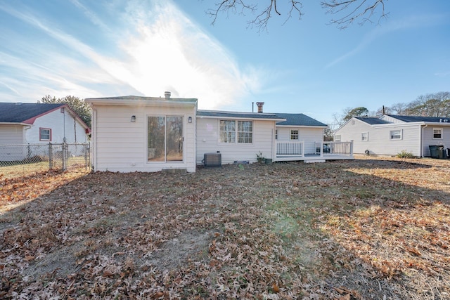 rear view of house featuring a wooden deck