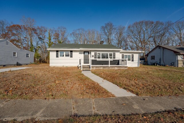 ranch-style home featuring a front yard