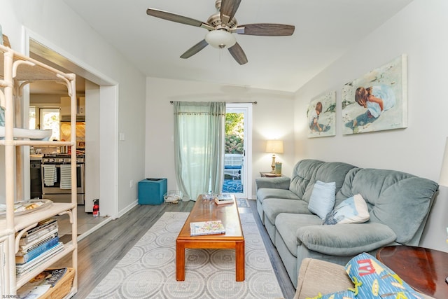 living room featuring hardwood / wood-style floors, ceiling fan, and lofted ceiling