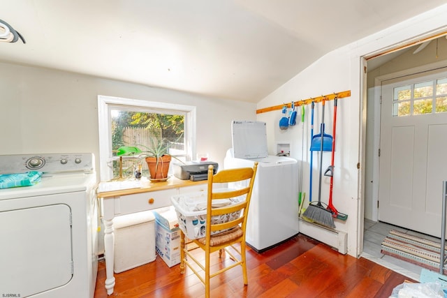 laundry room featuring independent washer and dryer, a baseboard heating unit, a wealth of natural light, and dark wood-type flooring