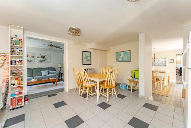 dining space with ceiling fan and light hardwood / wood-style floors