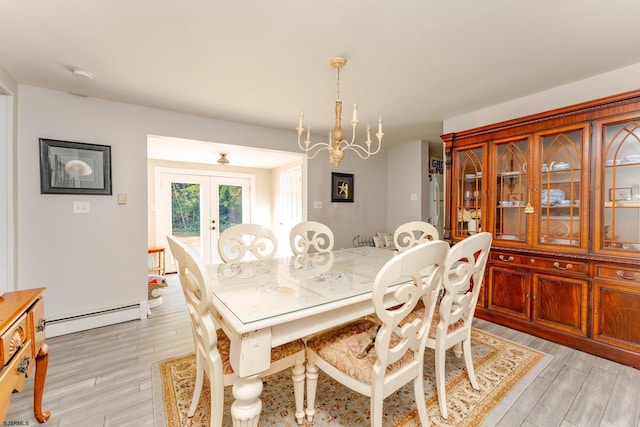 dining room with french doors, light wood-type flooring, a notable chandelier, and a baseboard heating unit