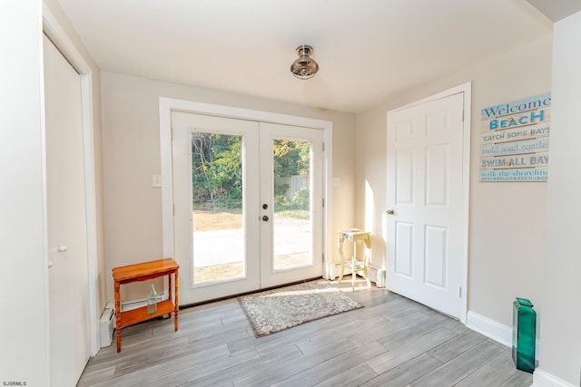 entryway with light hardwood / wood-style floors and french doors