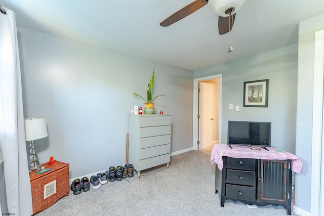 carpeted office space with ceiling fan