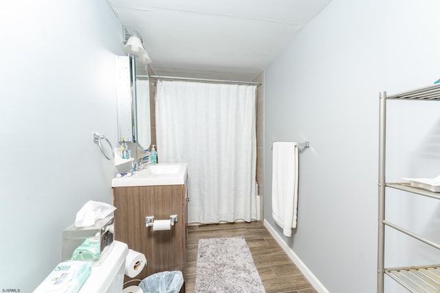 bathroom with vanity, wood-type flooring, and shower / bath combo