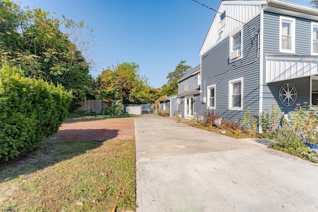 view of side of home with a lawn