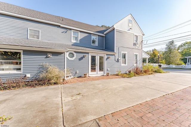 rear view of house featuring french doors