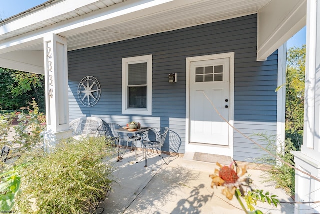 view of exterior entry with a porch