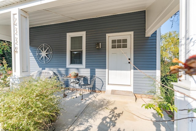 view of exterior entry with covered porch