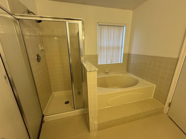 bathroom featuring plus walk in shower and tile patterned floors