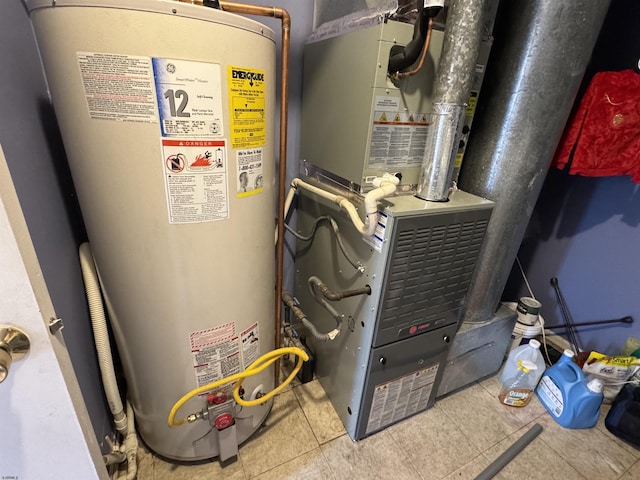 utility room with heating unit and water heater