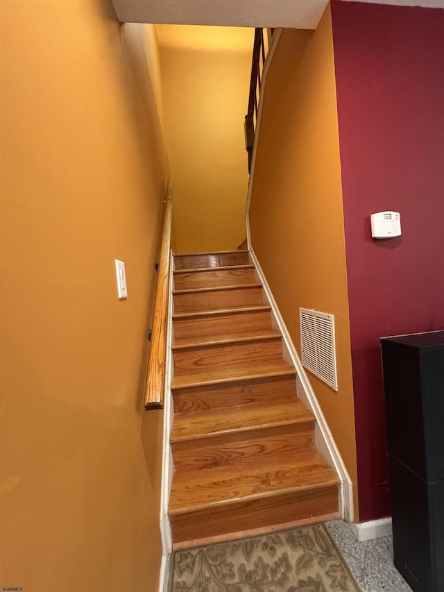 stairway with wood-type flooring