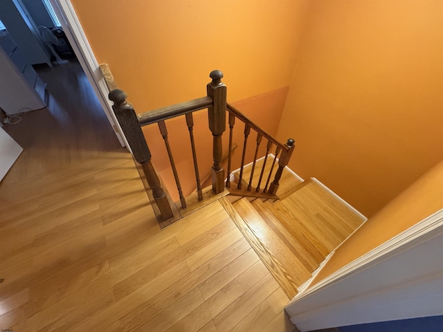 stairs featuring wood-type flooring