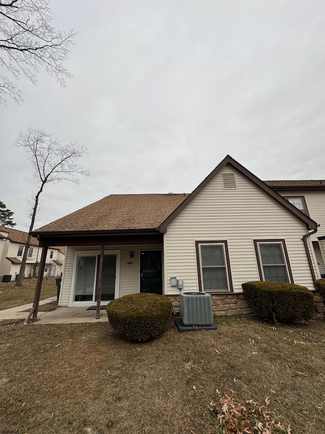 back of house with a yard, central AC, and a patio area