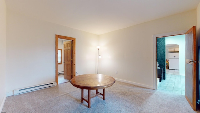 miscellaneous room featuring light colored carpet and a baseboard heating unit