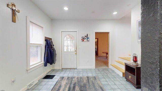 tiled entryway featuring a wealth of natural light