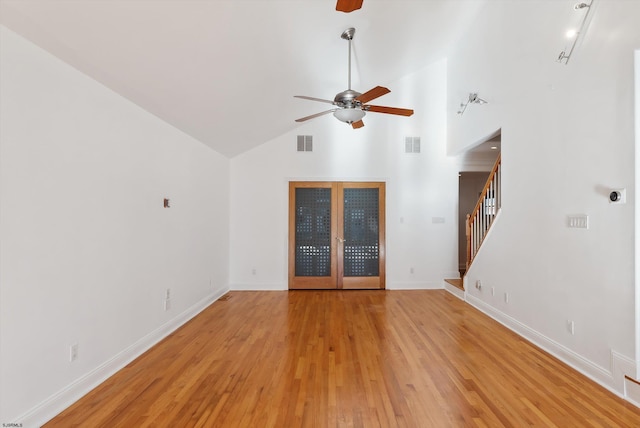 unfurnished living room with ceiling fan, high vaulted ceiling, and light hardwood / wood-style floors