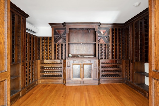 wine cellar featuring a wall mounted AC and hardwood / wood-style floors