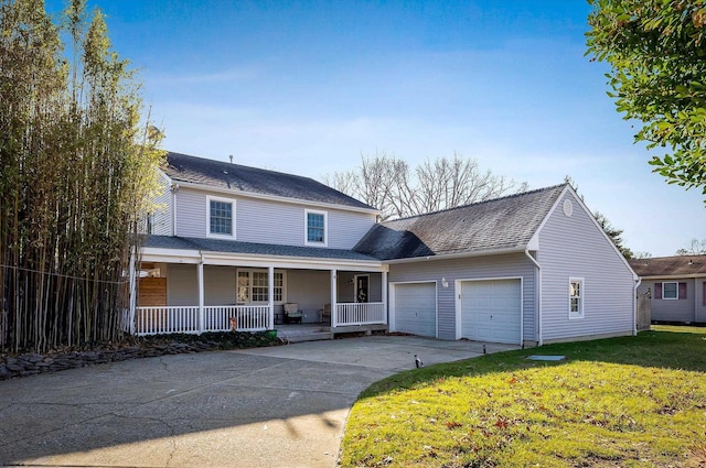 view of front facade with a porch, a garage, and a front lawn