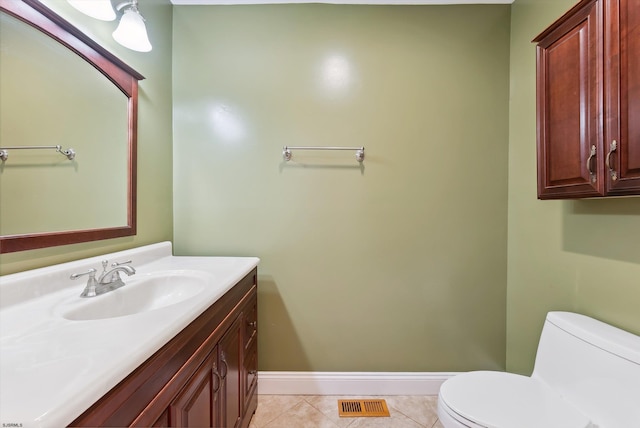 bathroom featuring tile patterned floors, vanity, and toilet