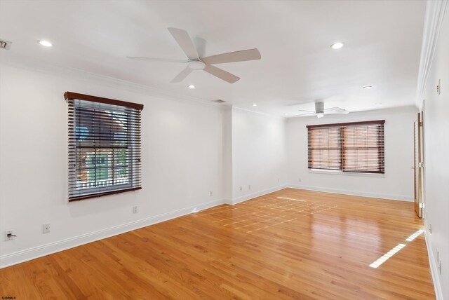 unfurnished room featuring ceiling fan, light hardwood / wood-style floors, and ornamental molding