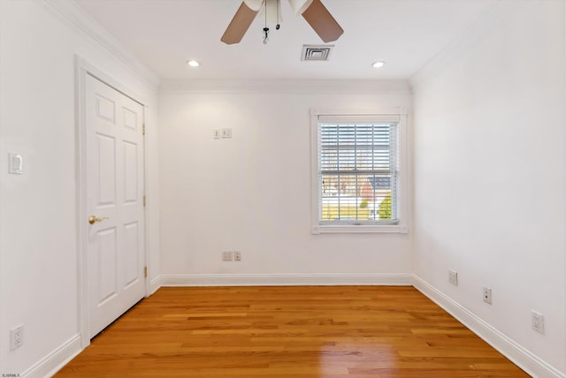 empty room with ceiling fan, light hardwood / wood-style floors, and ornamental molding