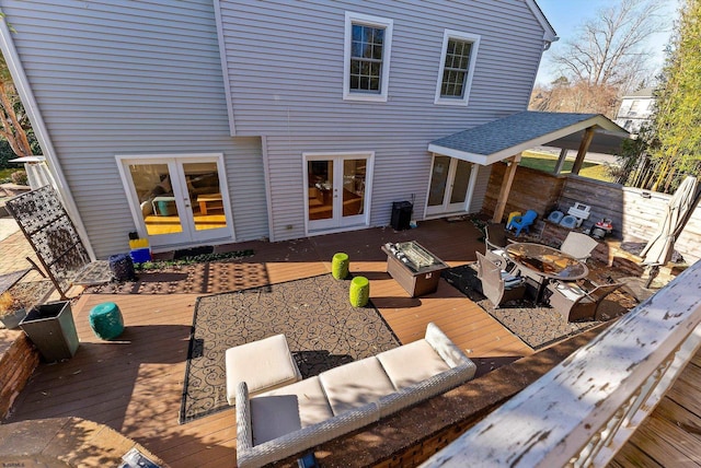 wooden terrace with french doors and an outdoor living space