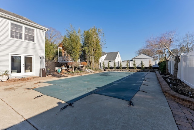 view of swimming pool with a patio area and french doors