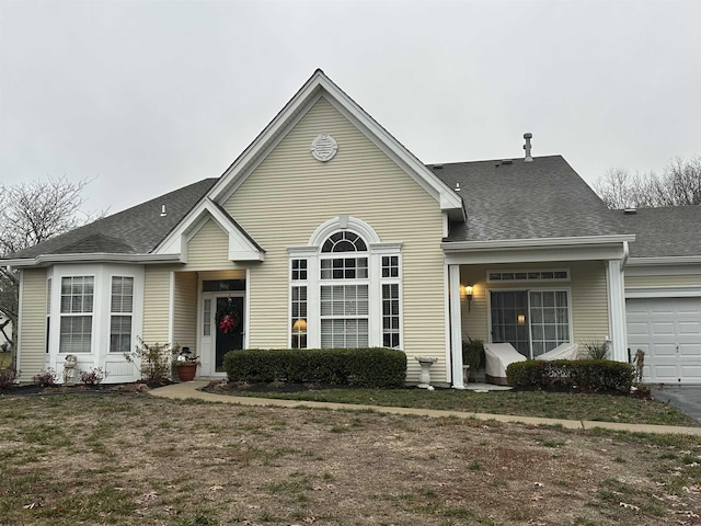 view of front facade with a garage and a front yard