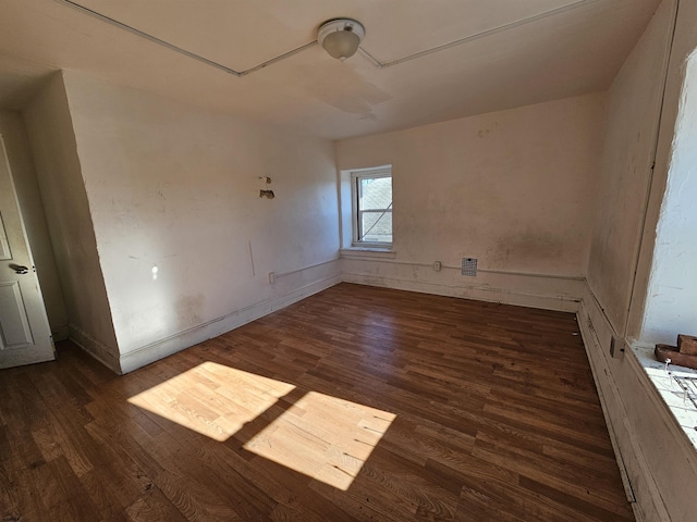 empty room with dark wood-type flooring