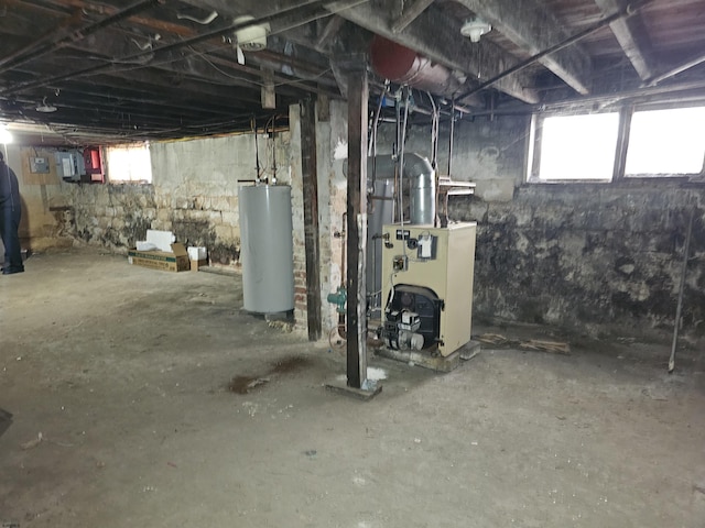 basement featuring gas water heater and a healthy amount of sunlight