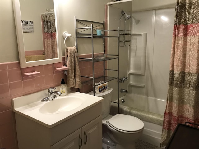 full bathroom featuring shower / bath combo, vanity, toilet, and tile walls