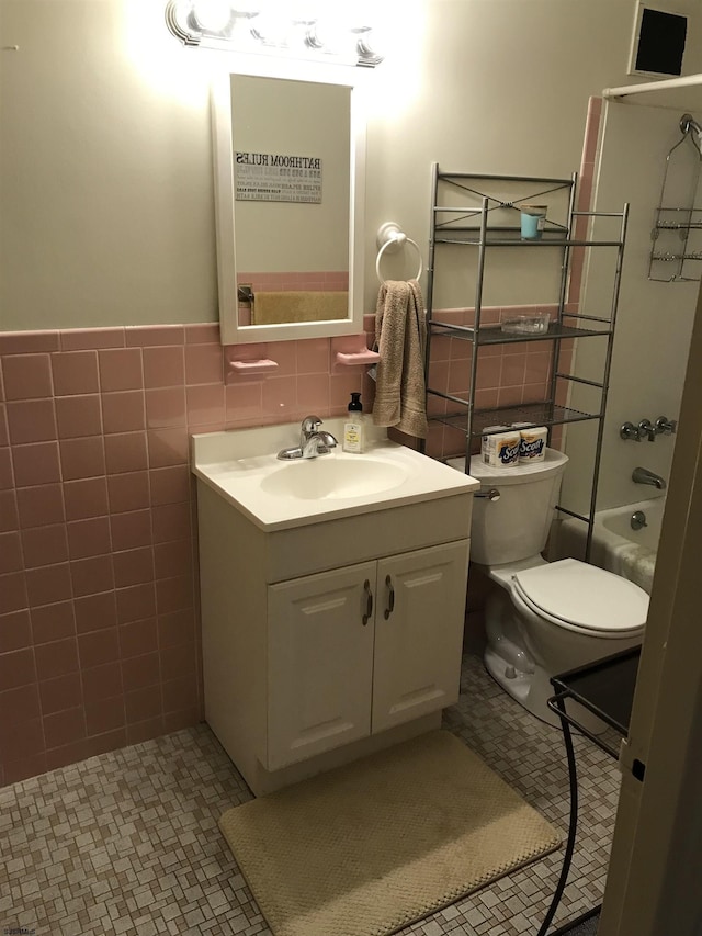 full bathroom featuring vanity, shower / bathing tub combination, tile walls, tile patterned flooring, and toilet