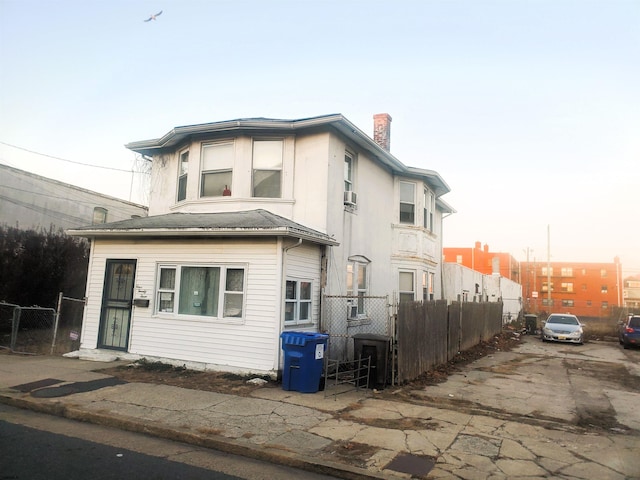 property exterior at dusk with cooling unit