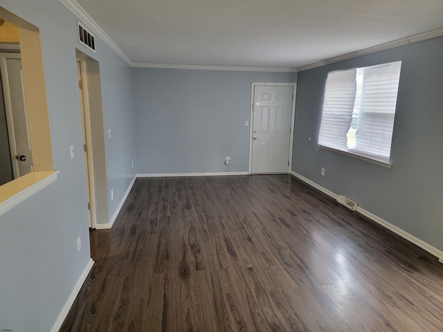 spare room with crown molding and dark hardwood / wood-style floors