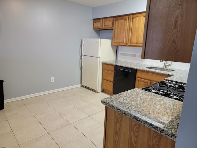 kitchen featuring stone counters, dishwasher, sink, white refrigerator, and backsplash