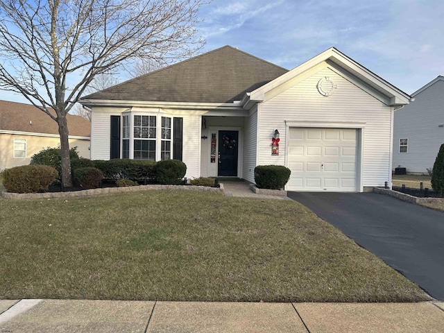 ranch-style house with a garage and a front lawn