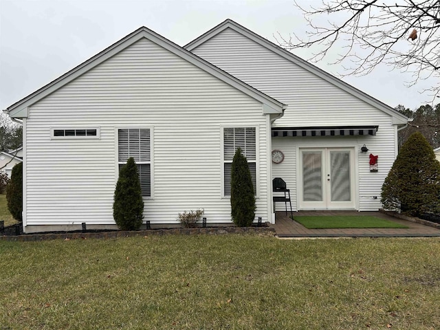 back of house with a yard and french doors