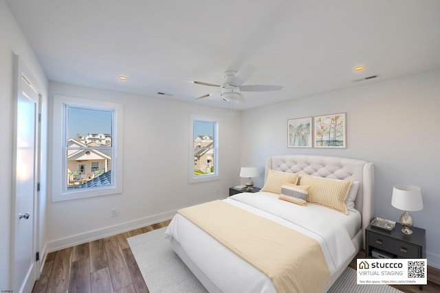 bedroom with wood-type flooring and ceiling fan