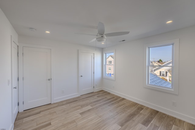 unfurnished bedroom featuring ceiling fan and light wood-type flooring