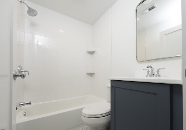 full bathroom featuring tiled shower / bath combo, toilet, and vanity