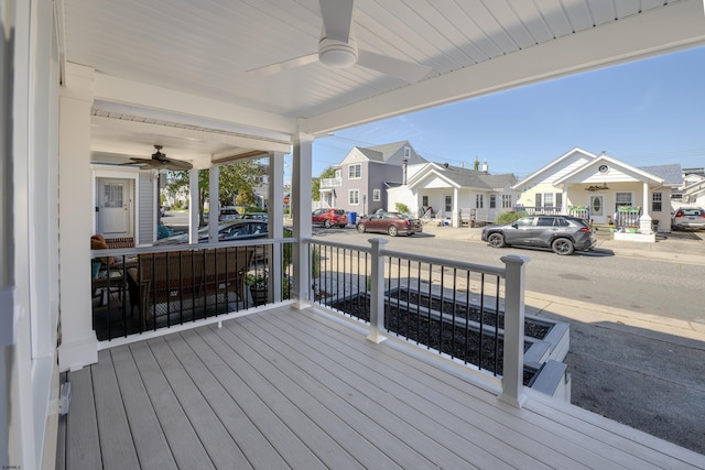 wooden deck featuring a porch and ceiling fan