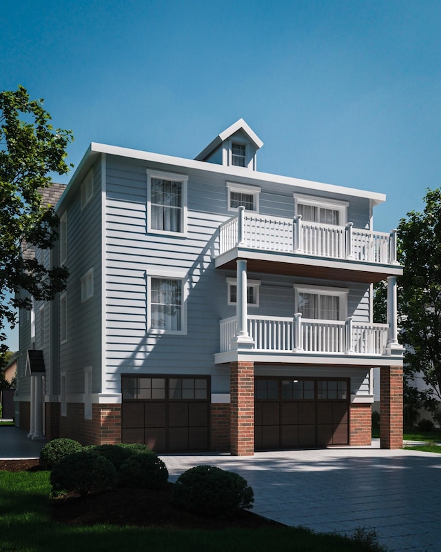 view of front of house featuring a garage and a balcony