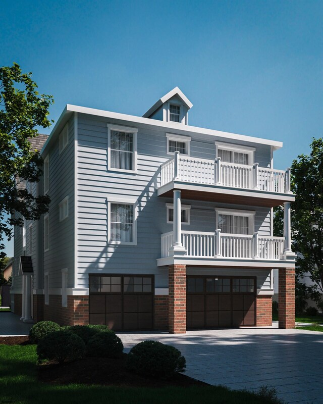 view of front of home featuring a garage and a balcony