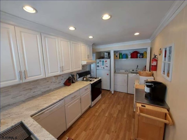 kitchen featuring light stone countertops, white appliances, and white cabinetry