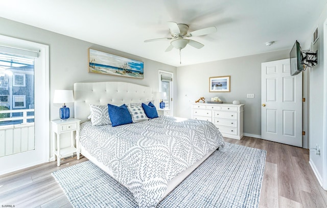 bedroom with light hardwood / wood-style flooring and ceiling fan