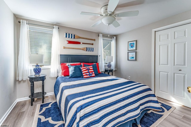 bedroom featuring ceiling fan, multiple windows, and a closet