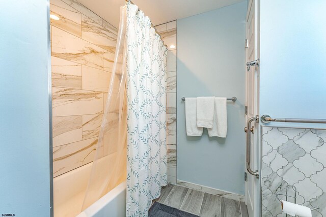 bathroom with shower / bath combination with curtain and hardwood / wood-style flooring