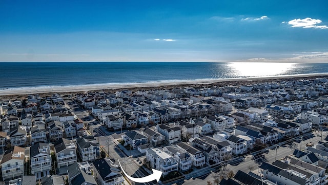 birds eye view of property featuring a beach view and a water view